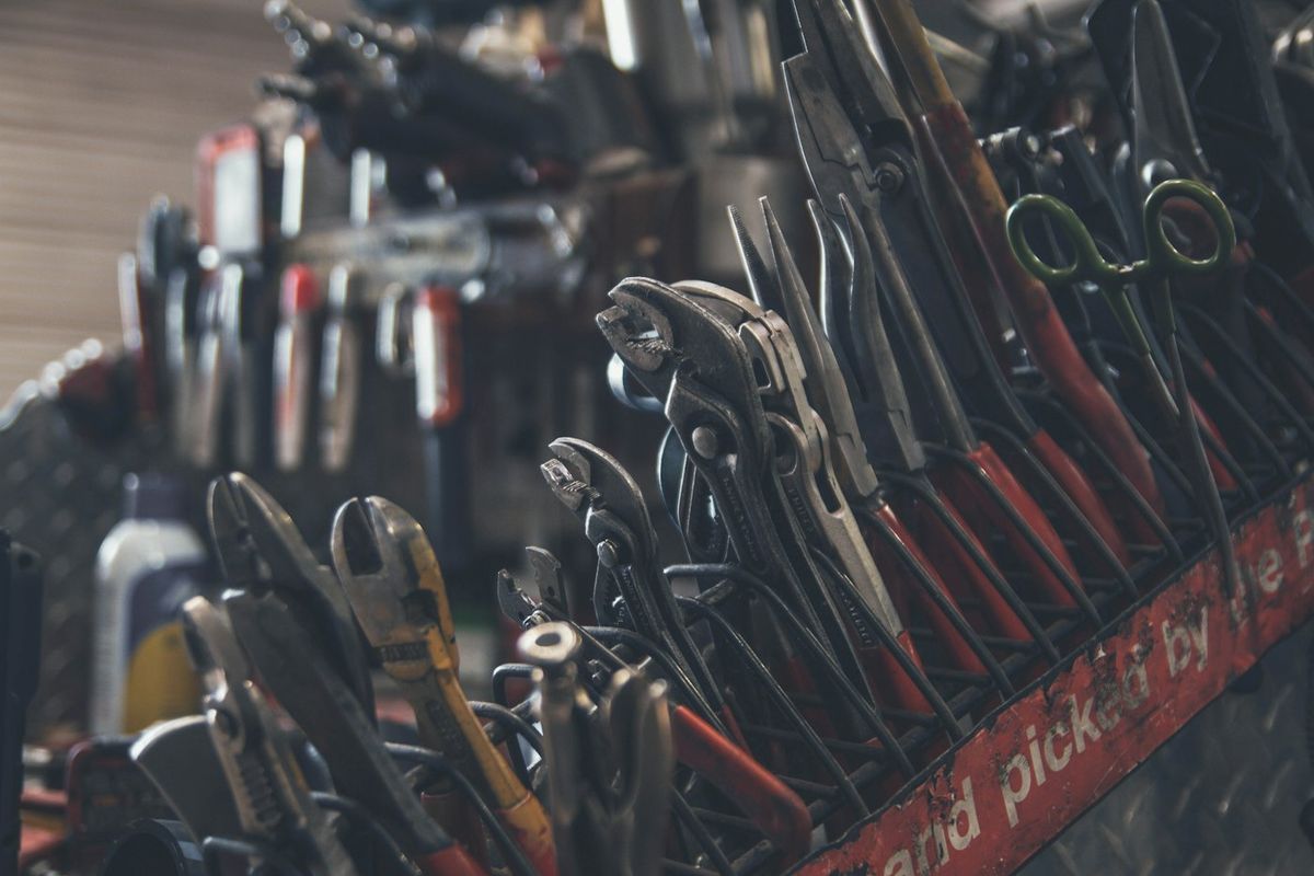 Hand tools laid out on a workshop surface